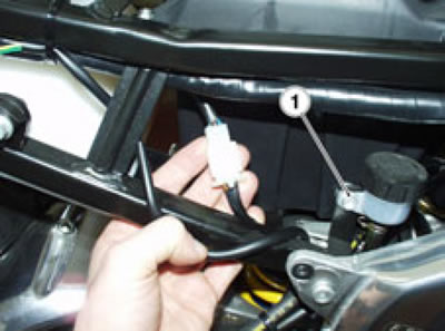 Move aside the rear brake fluid reservoir.